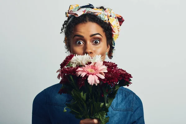 stock image I adore me some flower power. Studio shot of an attractive young woman holding a bunch of flowers against a grey background