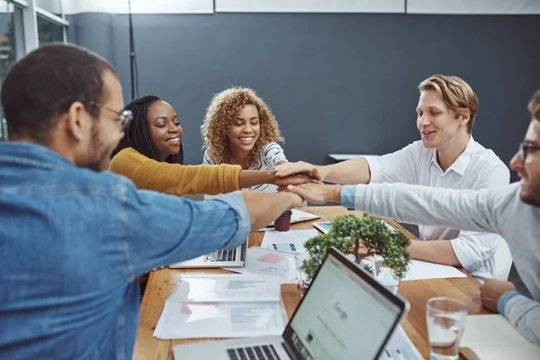 Stock image All for one. High angle shot of a group of businesspeople joining their hands together in unity