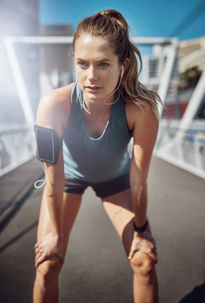 stock image Time for a break...a sporty young woman looking tired during a run