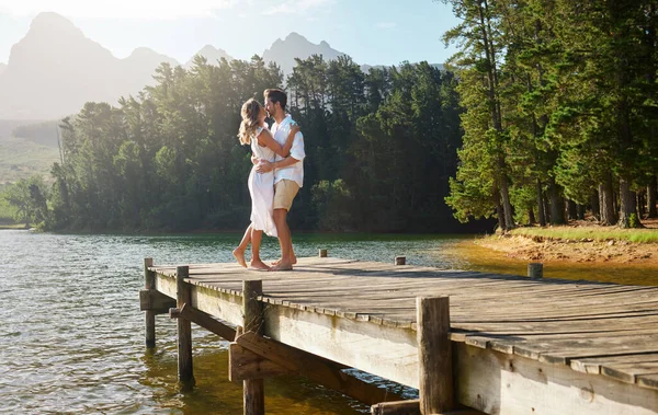 stock image Love, couple and dance at lake pier, smile and bonding together outdoors on vacation. Dancing date, having fun and happy man and woman on anniversary celebration for romantic holiday at summer creek