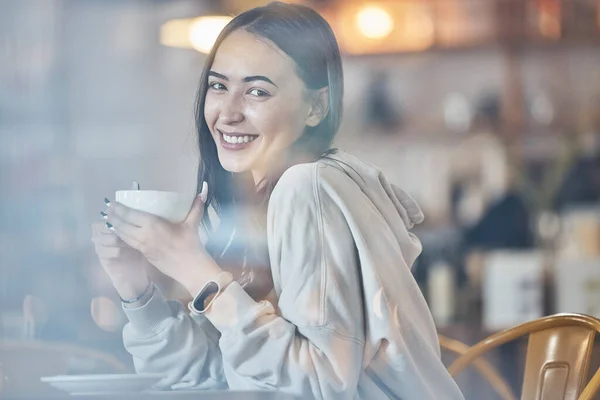 stock image Happy, cafe and portrait of a woman with a coffee, enjoying a drink and warm beverage. Smile, relax and a girl drinking a cappuccino, tea or latte at a restaurant in the morning for happiness.