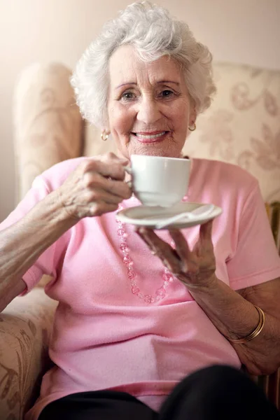 stock image Few things in life are pleasing than tea time. Portrait of a senior woman enjoying a warm beverage at home