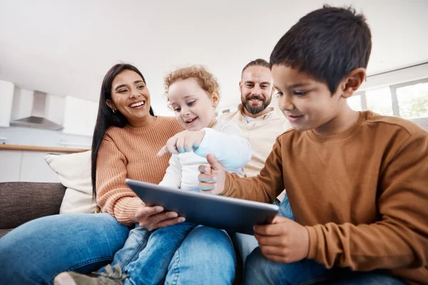 Happy, tablet and bonding with family on sofa for search, streaming and fun games. Technology, internet and connection with parents and children browsing online at home on social media app or website.