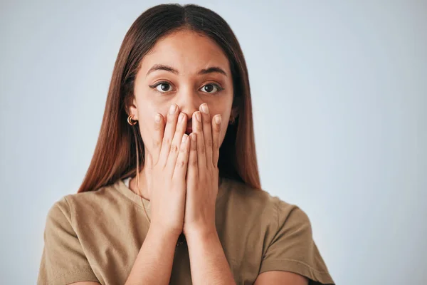 stock image Portrait, woman and surprise in a studio with a female cover mouth from shock. Isolated, grey background and hands on a face of a young person model with wow, worry and alert reaction from secret.