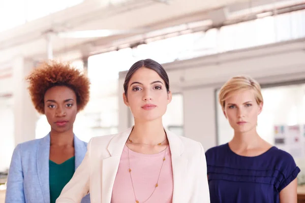 stock image We set out to change the world. Portrait of three female coworkers standing in an office