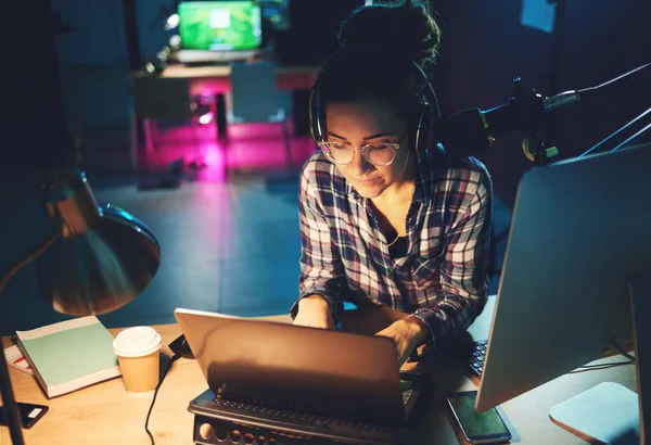 stock image Live streaming, computer and podcast woman typing news article, broadcast report or planning platform strategy at night. Journalist or person on laptop and microphone for student politics or radio.