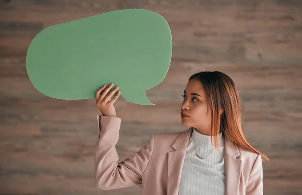 Business woman, speech bubble and wall background, blank sign for social media chat or notification. Professional person holding empty sign for announcement, info or opinion on ideas for startup chat.