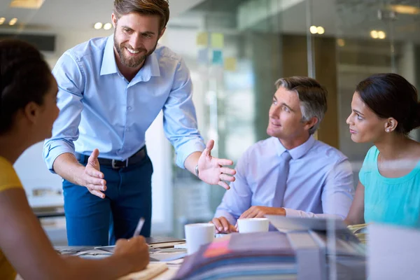 stock image Weve got this. four businesspeople in a meeting