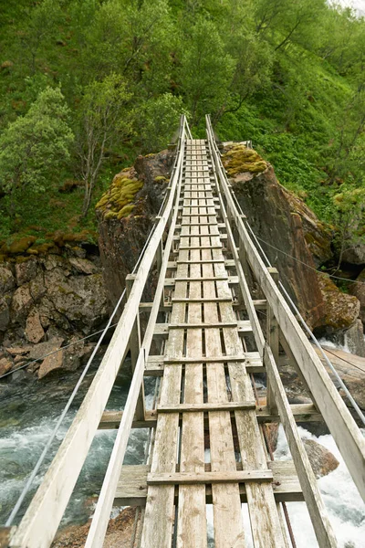 Suspension bridge in Norway. A narrow suspension bridge in mountain area in the northern part of Norway, Nordland
