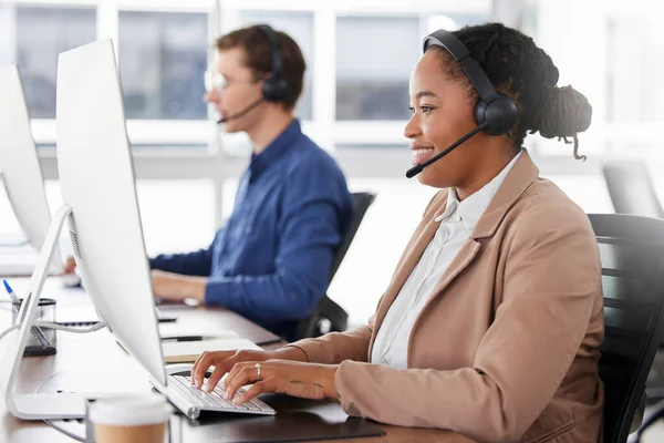 Black woman, call center and typing on computer, smile in office and working on customer service in workplace. Telemarketing, desktop and happiness of person, female sales agent or consultant writing.
