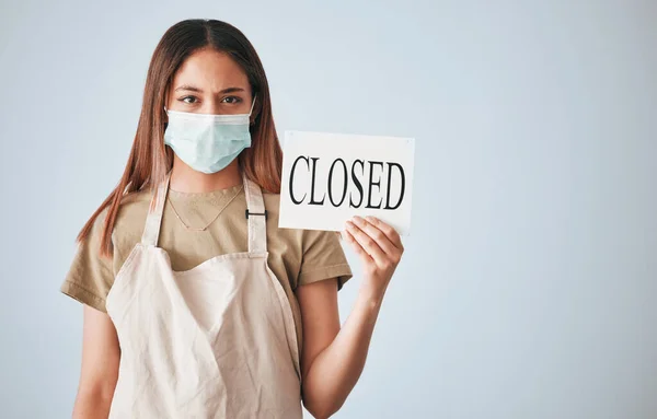 stock image Woman, closed sign and face mask for covid in studio for announcement isolated on white background mockup. Entrepreneur, small business owner and closing poster for pandemic with portrait of waitress.