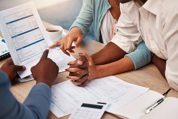 Couple holding hands, bank and application for loan, finance or mortgage to buy new home with documents. Black man, woman and financial advisor with credit review, paperwork and compliance in office.