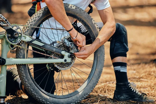 Maintenance, race and a man with a bicycle in nature for cycling, construction and building a bike. Fitness, sports and a biker with transportation. fixing a gear and wheels during cardio in a park.