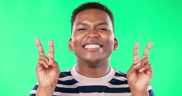 黑人男子 和平的标志和脸在绿色的屏幕上挂着微笑 幸福或兴奋的情绪通过工作室背景 在肖像 生活方式或图标中模仿 手势或手的男生 模特或天才学生 — 图库视频影像