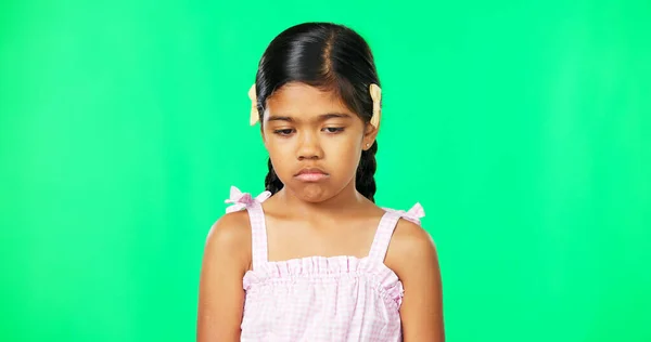 Sad, depression and face of child on green screen with upset, disappointed and unhappy facial expression. Portrait, mockup studio and isolated young girl with sadness, problem and moody for attention.