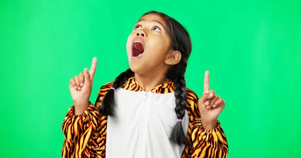 Shock, green screen and face of a child pointing isolated on a studio background. Wow, looking and portrait of a girl gesturing with hands on a mockup space backdrop for announcement or presentation.