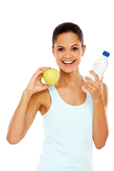 stock image She leads a healthy life. Portrait of a happy young woman holding a bottle of water and an apple