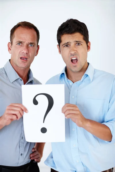 You want us to do what. two shocked men holding up a sign against a white background