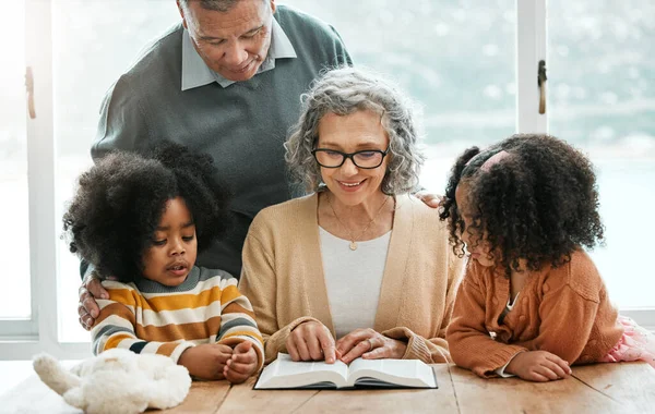 Bible, reading book or grandparents with children for learning, support or hope in Christianity education. Wellness, old man or grandmother studying or teaching kids siblings God in religion together.