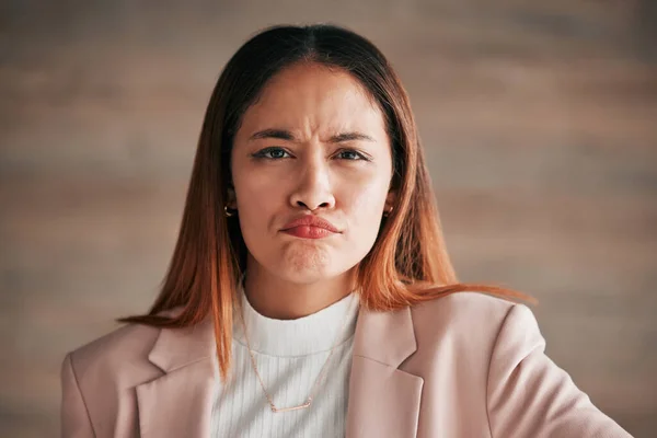 Portrait, frown and business woman in office confused, unsure or unhappy on wall background. Face, sad and angry corporate employee, doubt and emoji expression, overwhelmed and wondering at new job.