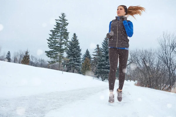 あなたは夏にそれを披露することができますので 冬に出て働く 雪の中を走りながら暖かい服を着た女性が — ストック写真