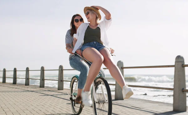 完璧な夏のデート ビーチの近くの遊歩道で一緒に自転車に乗って幸せな若いカップルの完全な長さのショット — ストック写真