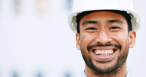 Face of a contractor and maintenance manager smiling and laughing at a construction site with copy space. Portrait of a happy engineer with a hardhat overseeing a successful project development.