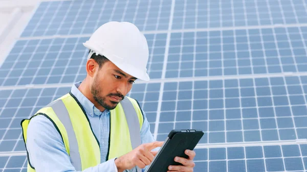 Solar, electricity and construction being done by an engineer while using a tablet for research or planning. Portrait of one young engineer browsing on technology.