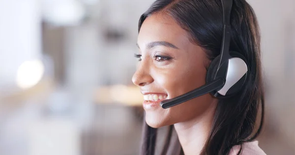 Call center agent helping client in a phone call giving great customer service. Customer support employee consulting clients online using headset. Professional friendly woman working at her desk.