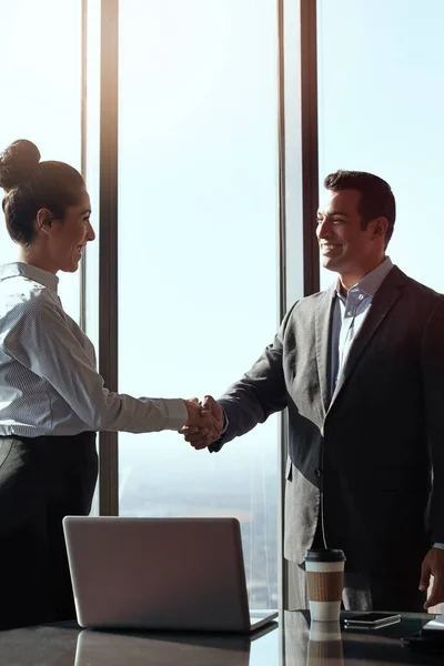 stock image Thanks for coming in. two young businesspeople shaking hands in their office