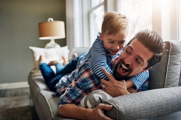 stock image Such a big hug. a father and his little son bonding together at home