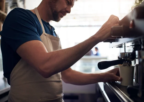 stock image The art of putting together the perfect blend. a barista operating a coffee machine in a cafe