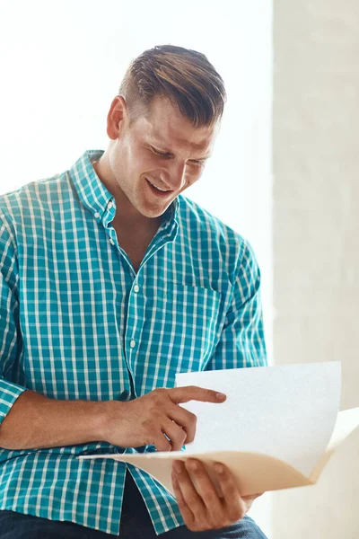 Looking His Creative Brief Handsome Young Businessman Looking Some Paperwork Stock Photo