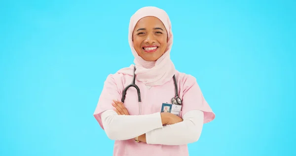 青い背景のモックアップに囲まれたスタジオでは イスラム教徒の女性 看護師の笑顔が交差しました 肖像画 医療専門家と自信を持って トルコから幸せと誇り高いイスラム人や外科医 — ストック写真