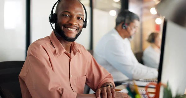 Call center, customer support and face of a black man consultant doing online consultation in the office. Customer service, sales employee and telemarketing agent working on crm strategy in workplace.