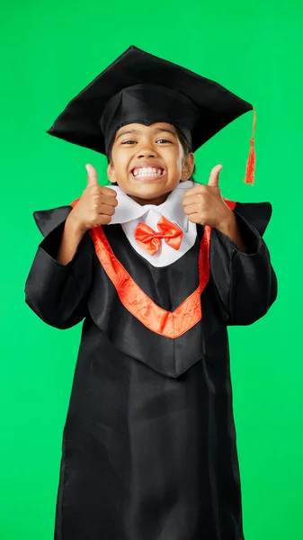 Graduation, happy and face of a child with a thumbs up on a green screen isolated on a studio background. Success, achievement and portrait of an excited girl with an emoji sign for education.
