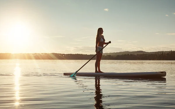 水は美しく 穏やかです 魅力的な若い女性のパドルボートが湖に乗り — ストック写真
