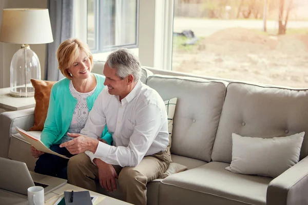 stock image Sorting their household finances together. a mature couple going over their finances at home