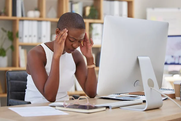 Headache, migraine and pain of woman on computer stress, depression or mental health risk in office for news. Confused, depressed or frustrated African business person with burnout or fatigue online.