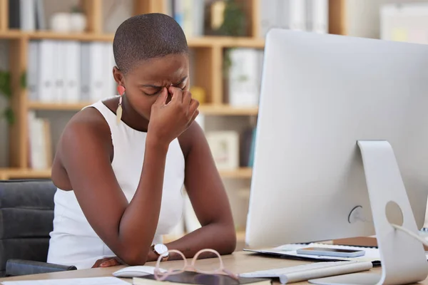 Headache, migraine and sad woman on computer stress, depression or mental health risk in office for news. Pain, depressed or angry African business person with burnout or fatigue for online career.