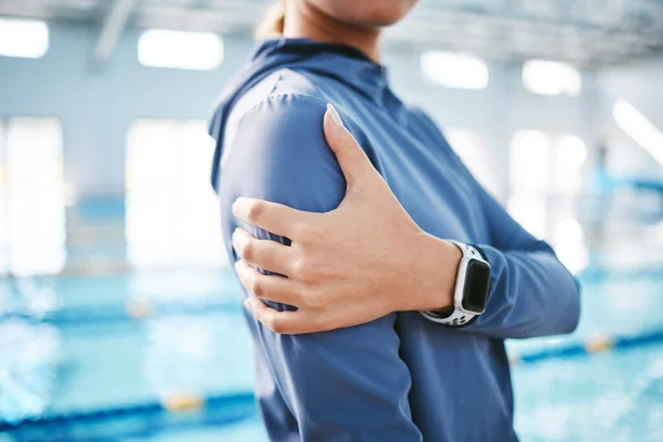 Woman, shoulder pain or closeup of swimmer with injury after exercise, training or workout accident. Hands, sports athlete or injured person with tendinitis, muscle or broken bone in practice by pool.
