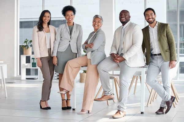 Team, diversity and portrait of business people in the office posing together after a meeting. Collaboration, staff and multiracial group of colleagues or friends standing in the modern workplace