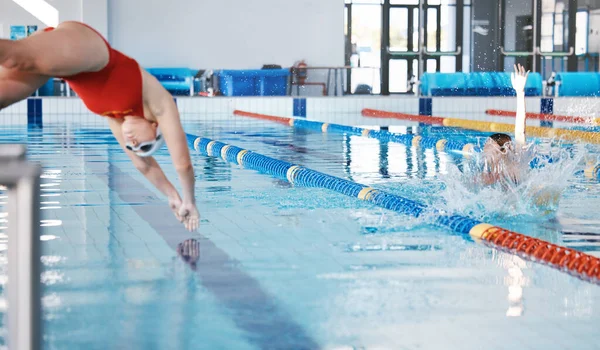 Sports, swimming pool and woman diving in water for training, exercise and workout for competition. Fitness, swimmer and professional person dive, athlete in action and jump for health and wellness
