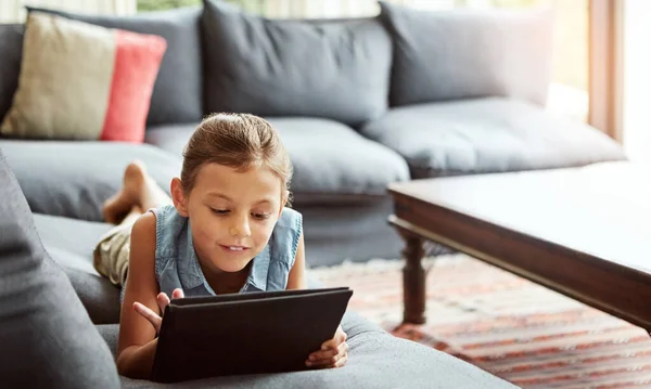 stock image Shes one connected kid. a little girl using a digital tablet at home