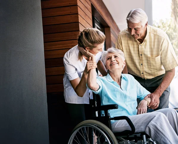 stock image I appreciate your support so much, my dear. a senior couple and a nurse outside a retirement home