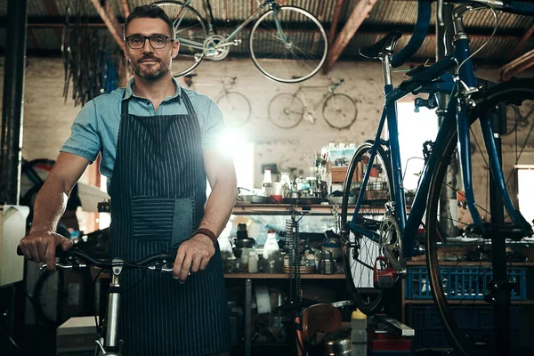 这个行业领先的自行车专家 一个成熟男子在自行车修理店工作的画像 — 图库照片