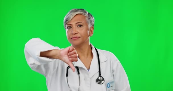 医生的评论 绿色屏幕和脸在工作室的背景下让一个大拇指垂下来 不快乐 成熟的女性 一个带着不同意 失望或坏消息的女性 — 图库视频影像