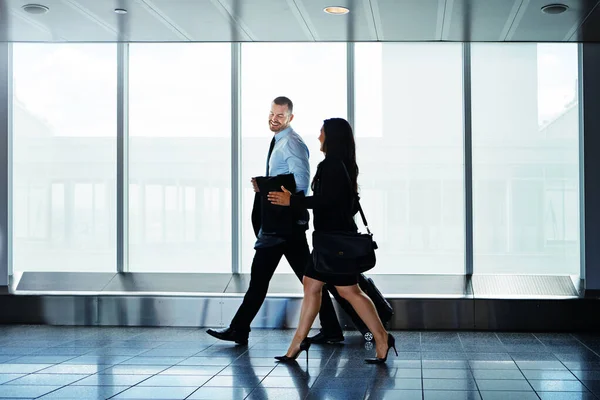 世界中で事業を展開している 2人のビジネスマンが空港を歩いている間に — ストック写真
