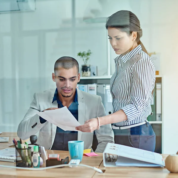 stock image We can redraft this data over here...two businesspeople looking through some paperwork in an office