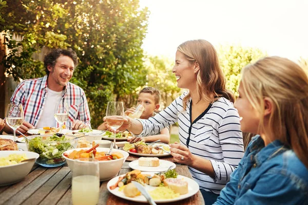 Awesome food brings people together. a family eating lunch together outdoors